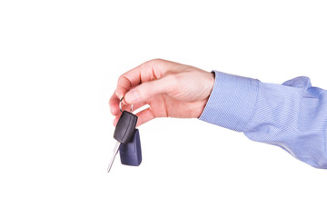 Male hand holding a car key . New car concept