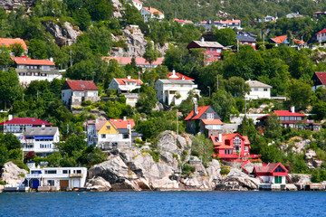 Houses and huts on the shore and  hills of Bergen Fjord. © asife