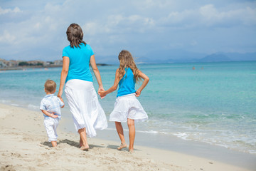 Mother with his two kids on beach