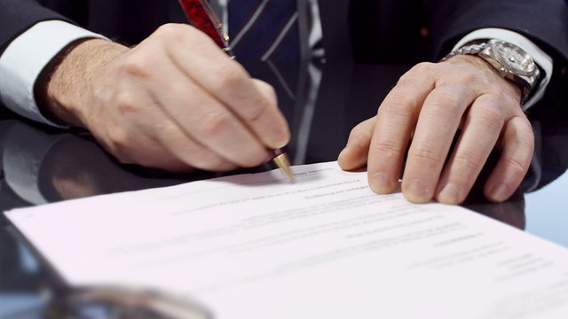 Close up of businessman signing a contract