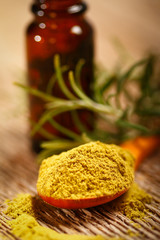 Bottle of aromatic essence oil, fresh and powdered rosemary