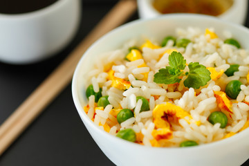 Bowl of fried rice, peas and egg