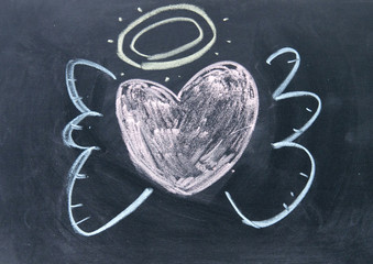 heart angel sign drawn with chalk on blackboard