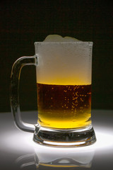 glass of beer on dark background