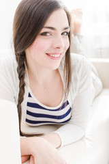 Young woman relaxing and smiling at home
