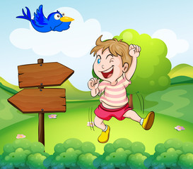 Obraz na płótnie Canvas A boy beside a wooden arrow and the blue bird