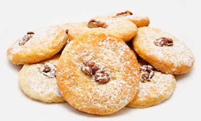 Heap of delicious cookies icing sugar with walnut isolated