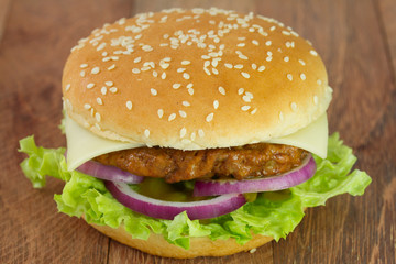 cheeseburger on dark wooden table