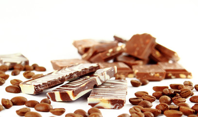 sweet chocolate candies and coffee beans isolated