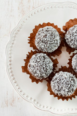 truffles with coconut on the white plate