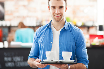 Waiter with coffee on tray