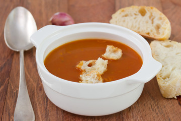 tomato soup with bread in white bowl