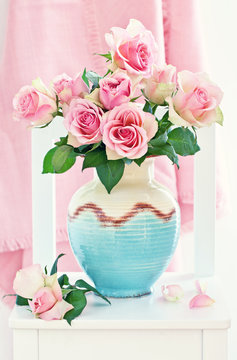 Beautiful fresh roses in a ceramic vase.