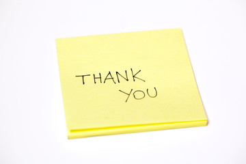 Thank you written on a post-it sticky note, isolated on white