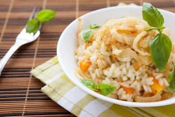 appetizing risotto with vegetables in white bowl