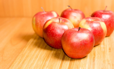 Fresh red apples on a wooden background