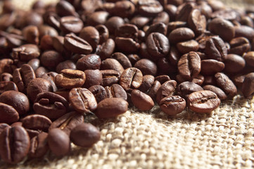 Roasted coffee beans on canvas.
