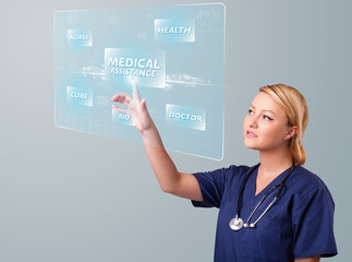 Young nurse pressing modern medical type of buttons
