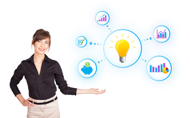 Young woman presenting light bulb with colorful graphs and diagr