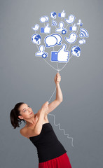 Pretty woman holding social icon balloon