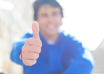 Portrait Of Young Man Showing Thumb-up Sign