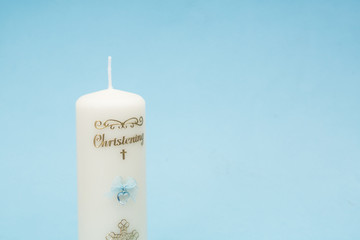Christening candle with blue detail and copy space