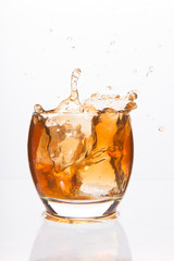 Tumbler glass with brown alcohol