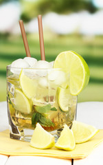 Glass of cocktail with lime and mint