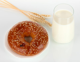 Bread roll and glass of milk isolated on white
