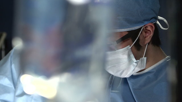 Asian surgeon working with assistant