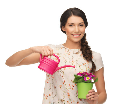 housewife with flower in pot and watering can