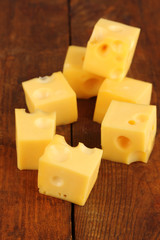 Cheese cubes on wooden table