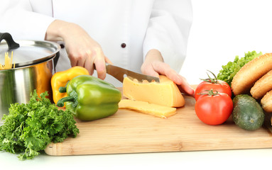 Female hands cutting cheese, isolated on white