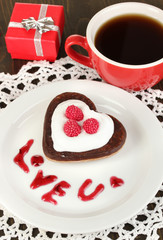 Chocolate cookie in form of heart with cup of coffee