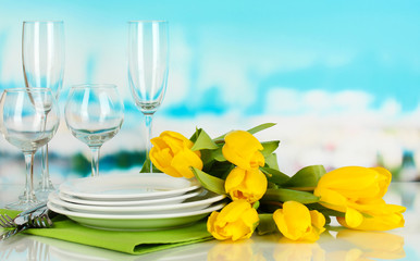Yellow tulips and utensils for serving