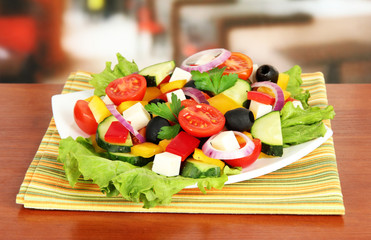 Tasty Greek salad on table in cafe