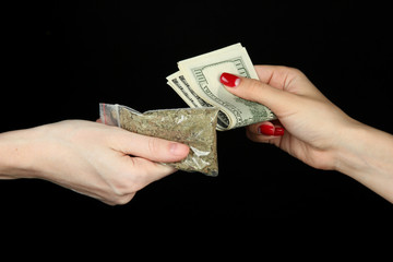 Dealer sells drug bag, isolated on black