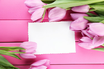 Beautiful bouquet of purple tulips and blank card