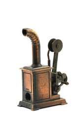 Vintage brass pencil sharpener in shape of machine on white