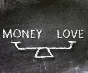 Fototapeta premium Balance of money and love on blackboard 
