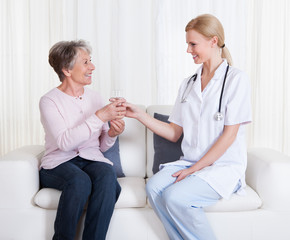 Portrait Of Doctor And Patient Sitting On Couch