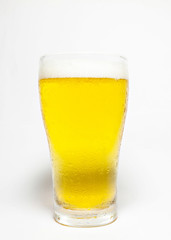 Frosty glass of light beer isolated on a white background