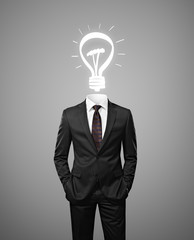 businessman with lamp instead of head on a gray background