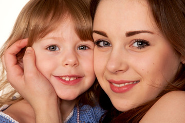 Two sisters, teenager and little girl. Face closeup.