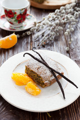 yummy Poppy cake with orange on white plate