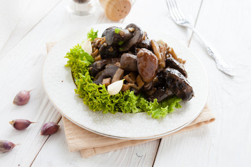 fried wild mushrooms on white plate