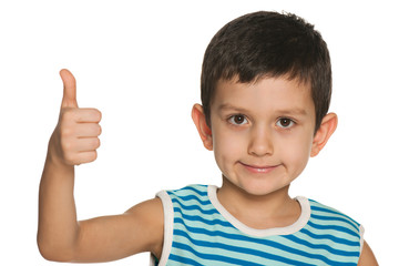 Closeup portrait of a boy holds his thumb up