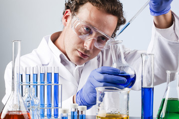 lab technician controlling colour of chemical solution