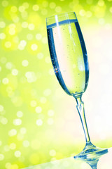 Champagne glasses on the green background