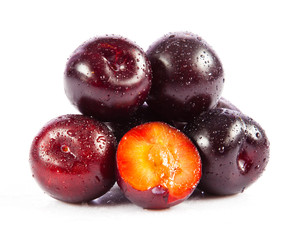 Red plum fruit isolated on white background.  Fresh ripe washed